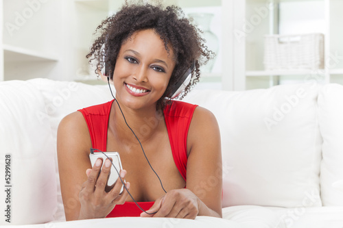 Photo: African American Girl Listening to MP3 Player Headphones African American Girl Listening to MP3 Player Headphones