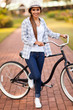 young woman with her bike at the park