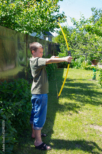 Photo: boy shooting a bow boy shooting a bow