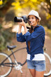 young woman taking pictures at the park
