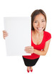 Photo: Showing woman holding white blank sign placard Showing woman holding white blank sign placard