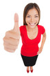 Photo: Woman giving thumbs up approval hand sign gesture Woman giving thumbs up approval hand sign gesture