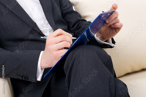 Photo: male psychologist being ready to take notes male psychologist being ready to take notes