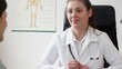 Smiling doctor talking to her female patient at office, tracking