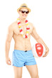 Shirtless man in swimming shorts, holding a beach ball