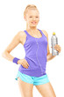 Young female in running outfit posing with a drink bottle