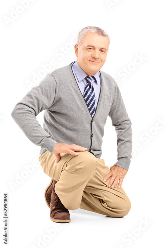 Photo: Smiling mature man kneeling Smiling mature man kneeling