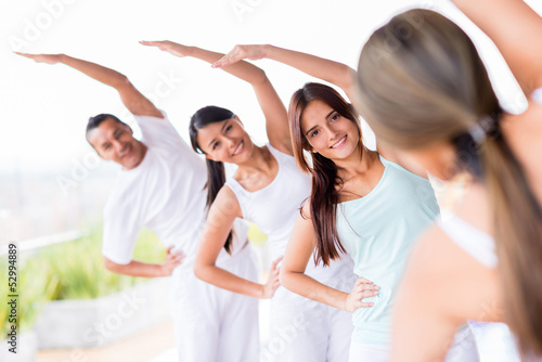 Photo: Yoga group stretching Yoga group stretching
