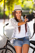 young woman taking self portrait outdoors