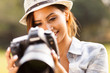 pretty woman reviewing photos on camera