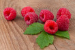 raspberry with leafs on old wooden table