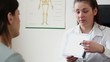 Doctor explaining something on tablet computer to patient