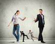 Businesspeople with marionettes