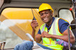 african bulldozer operator talking on walkie talkie