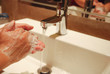washing hands with soap under running water