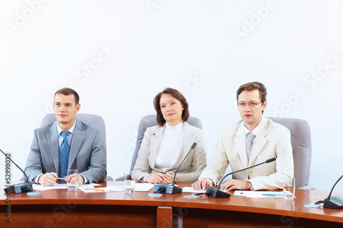 Photo: Three businesspeople at meeting Three businesspeople at meeting
