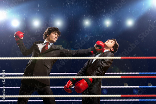 Photo: Two young businessman boxing Two young businessman boxing