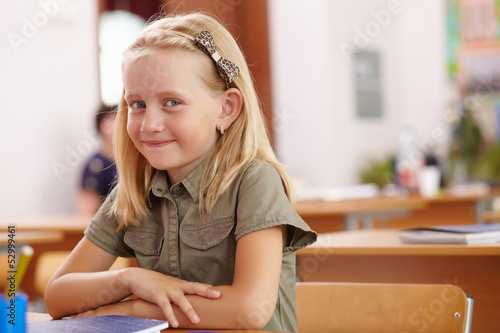Photo: Little girl at school class Little girl at school class