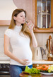 Attractive pregnant woman drinking water