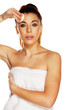 Beautiful woman cleaning her forehead