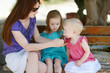 Young mother and her daugthters eating ice cream