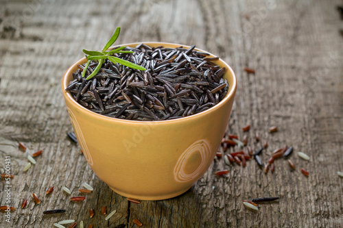 Photo: rice in a bowls with on wooden table rice in a bowls with on wooden table