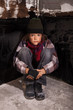 Foto: Poor beggar child sitting on the street Poor beggar child sitting on the street