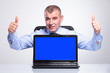Photo: old business man shows laptop and thumbs up old business man shows laptop and thumbs up