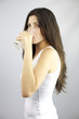 Beautiful woman drinking glass of milk