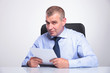 Photo: old business man at desk holds papers old business man at desk holds papers