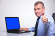 Photo: old business man shows ok from laptop old business man shows ok from laptop