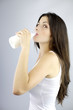 Happy woman drinking milk looking