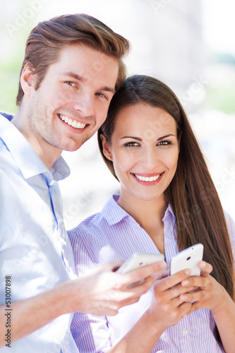 Photo: Couple with mobile phones Couple with mobile phones