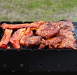 bbq ribs and bacon on a grill with charcoal