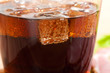 cola with ice cubes close up