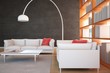 Divani libri lampada e muro nero
