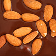 Photo: Pouring hot melted chocolate and almond nuts Pouring hot melted chocolate and almond nuts