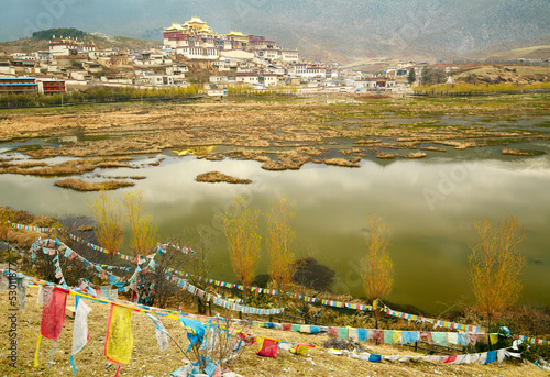 Photo: Landscape with tibetan monastery and lake Landscape with tibetan monastery and lake