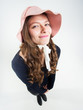 cute girl with funny hat smiling in the studio