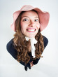 cute girl with funny hat smiling in the studio