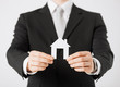 man hands holding paper house