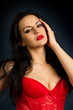 woman in beautiful red lingerie on dark background