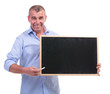 Photo: casual middle aged man presents blackboard casual middle aged man presents blackboard