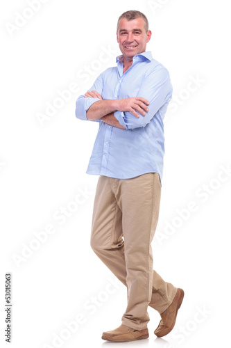 Photo: casual middle aged man with arms crossed casual middle aged man with arms crossed