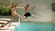 Happy siblings diving into the swimming pool