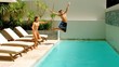 Siblings diving into the swimming-pool