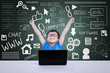 Boy winning computer science competition using laptop in class