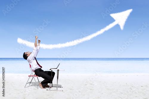 Photo: Businessman laughing looking at success arrow sign Businessman laughing looking at success arrow sign