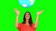 Woman throwing a globe on green screen
