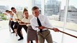 Business people pulling a rope together